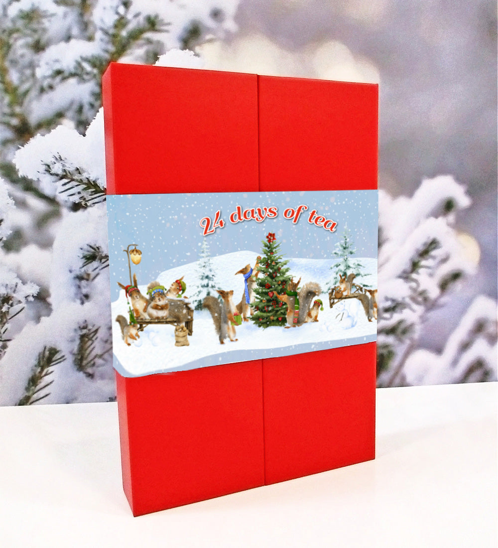 Red tea advent calendar with Christmas scene design against a snowy background