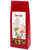 Apple Crisp herbal fruit tea in a red bag with a festive gnome label and a clear window showing the loose tea blend.