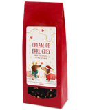 Cream of Earl Grey black tea, 100g, in a red bag with two festive dachshunds on the label and a clear window showing the tea.