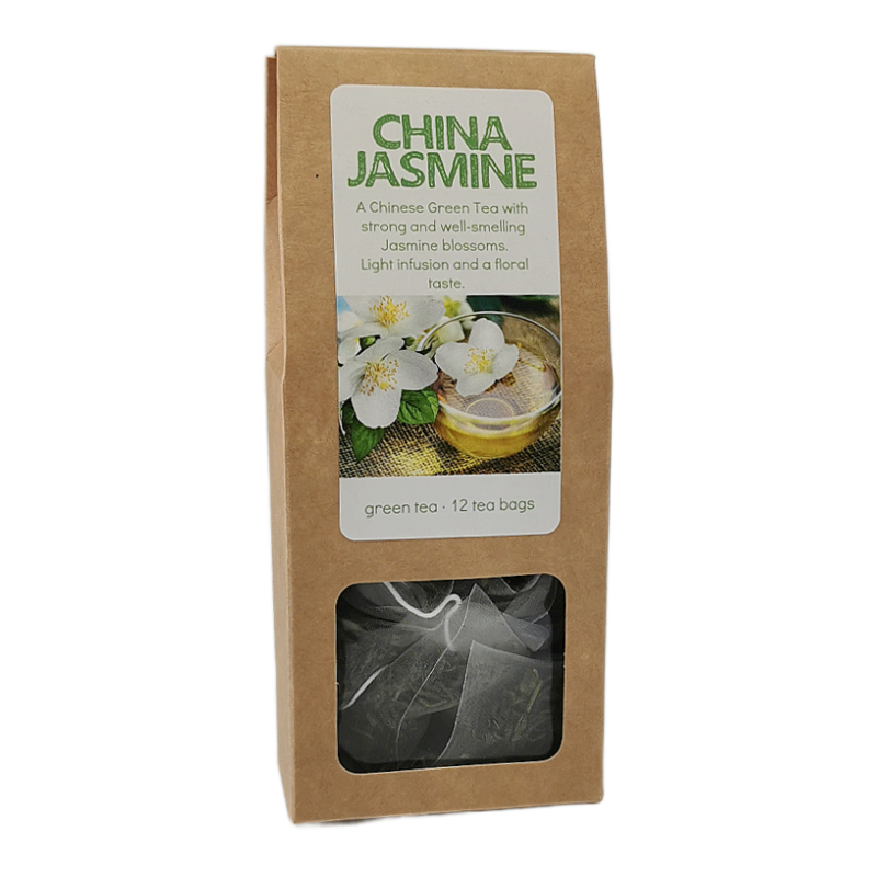 A package of China Jasmine green tea in a brown kraft paper bag with a clear window showing dark tea bags inside. The front label features green text and an image of white jasmine blossoms.