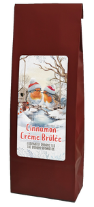 Red gift bag with a winter scene label, filled with Cinnamon Crème brûlée herbal tea.