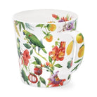 Mug with colourful floral and fruit pattern on a white background