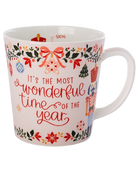 White Christmas mug with “It’s the most wonderful time of the year” in red lettering, surrounded by nutcrackers, bows, ornaments, and festive foliage.