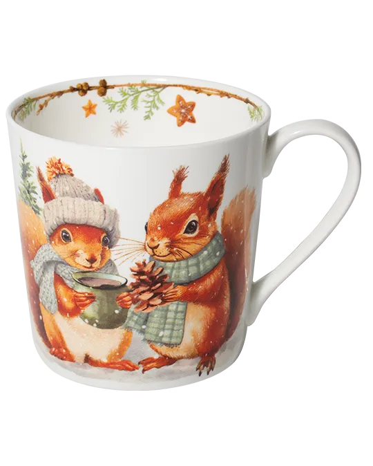 White mug featuring two red squirrels in winter scarves, one holding a green cup and the other a pine cone, with stars inside the rim.