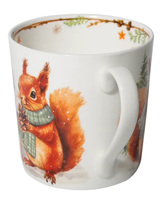 Side view of a white mug showing a red squirrel wearing a green scarf and holding a pine cone beside the handle.