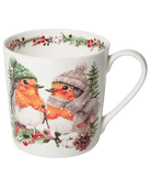 White mug featuring two robins in knitted winter hats, one wearing a scarf, surrounded by snowy greenery, red berries, and a pine cone.