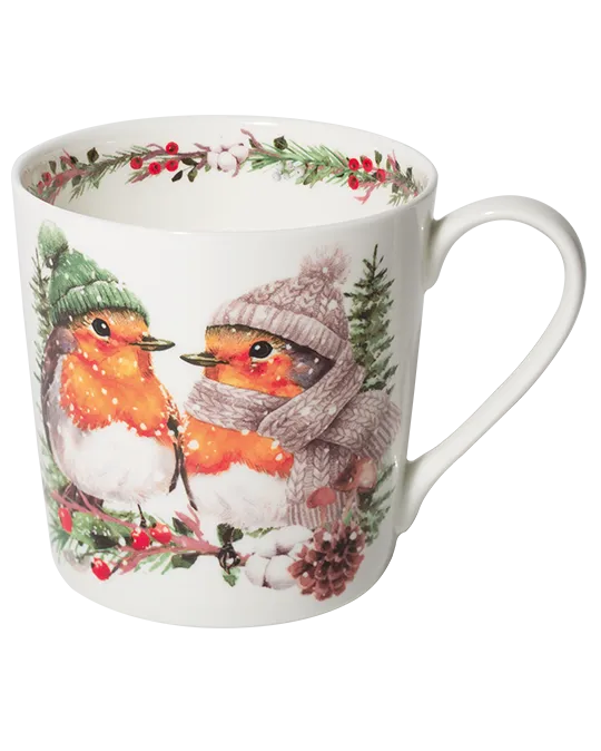 White mug featuring two robins in knitted winter hats, one wearing a scarf, surrounded by snowy greenery, red berries, and a pine cone.
