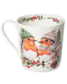 White mug with the handle on the left, featuring two robins in green and mauve winter hats perched on a snowy branch with red berries.