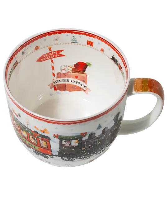 Top view of a Winter Express mug showing a train station sign and luggage illustration inside, with a miniature train around the inner rim.