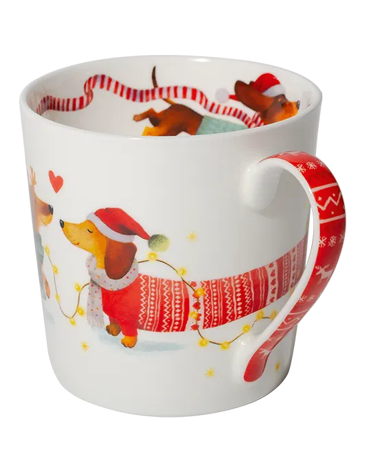 Side view of a dachshund mug showing a dog in a Santa hat and red patterned jumper beside a matching red festive handle.