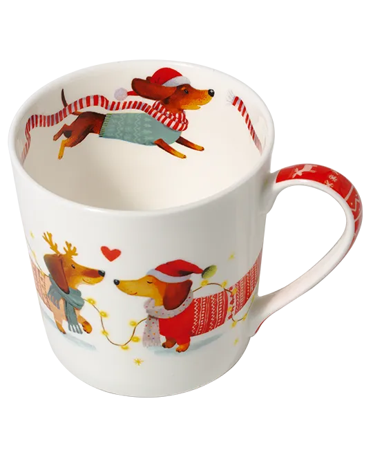 Top view of a dachshund mug showing a dog in a Santa hat and teal jumper with a flowing red-and-white scarf inside the rim.