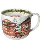White jumbo mug featuring snowy wooden market stalls with baked goods and gifts, evergreen trees, and a green garland inside the rim.