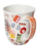 White mug decorated with colourful balls of yarn, knitting needles, and a knitting bag with a heart detail.