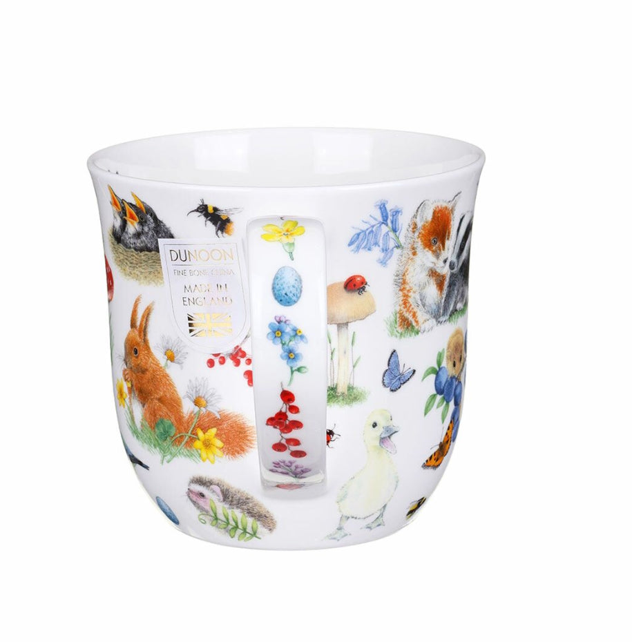 White mug with colourful animal illustrations on a white background