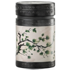 Akashi 150 g tea tin with green pine branches on a cream background, a black lid and textured black trim. 