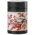Akashi 150 g tea tin with red blossom branches on a cream background, a black lid and textured black trim.