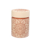 Decorative cylindrical container with a patterned design on a beige background