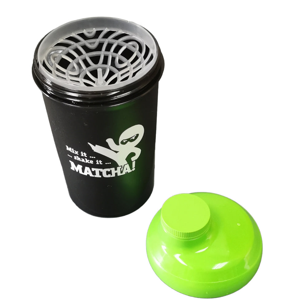 Matcha green tea powder shaker with black container and green lid on a white background
