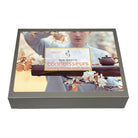 Tea box with a person holding a teapot and floral elements, featuring 'tea desire connoisseurs' branding.
