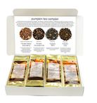 A white gift box labeled 'pumpkin tea sampler' with the lid open, showing four individually wrapped tea bags and a printed insert with four pumpkin tea blends pictured and described.