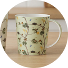 Mug with nature-themed design on a wooden surface