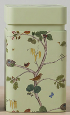 Green tin box with nature-themed design featuring birds and trees on a beige background